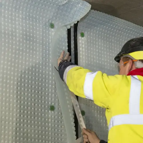 Damp Proofer installing cavity drain membrane